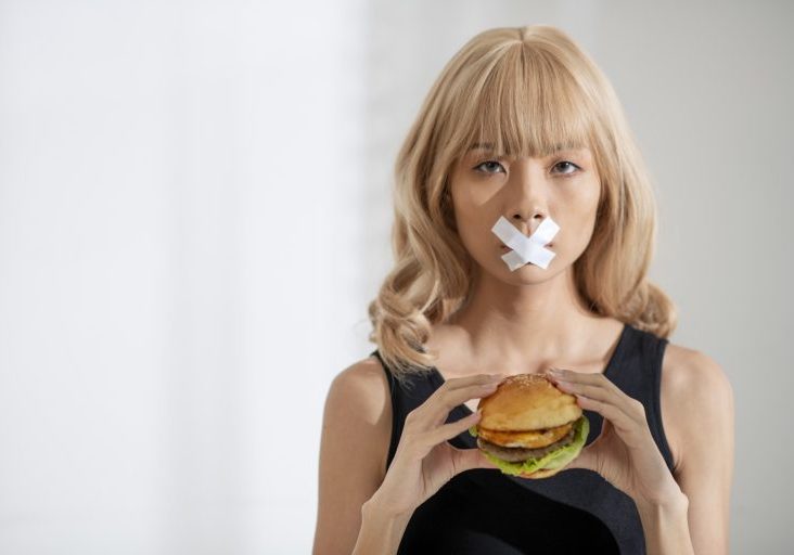 close-up-woman-holding-burger