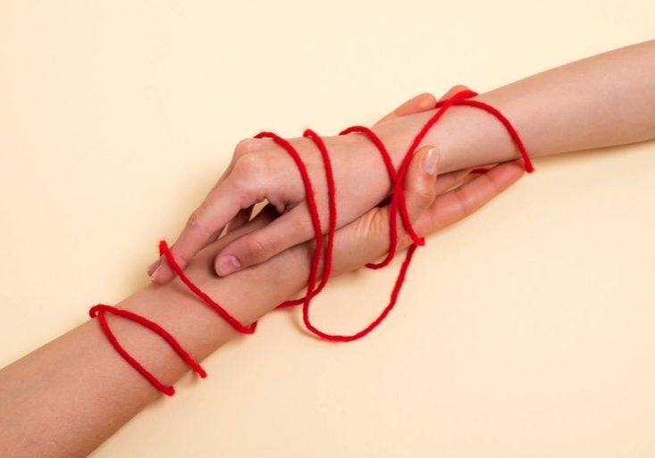human-hands-connected-with-red-thread